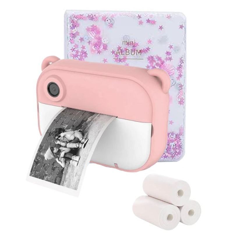 Pink Kid Instant Print Camera with bear ears printing a black and white photo, accompanied by a floral mini photo album and thermal paper rolls