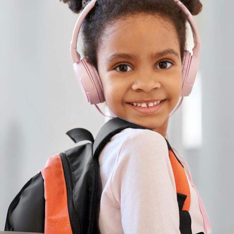 child wearing pink headset smiling with backpack using MP3 Player With Headset Halloween Collection