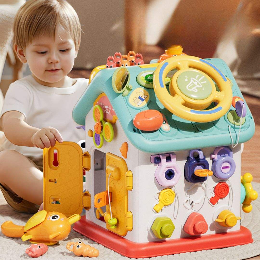 Toddler playing with Montessori Busy House toy enhancing fine motor skills and imaginative play