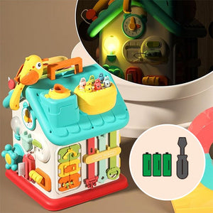 Montessori Busy House toy with lights, buttons, and doors for fine motor skill development in toddlers.