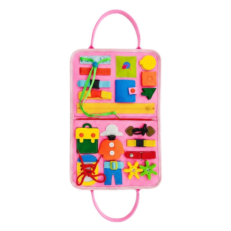 Toddler playing with Little Hands & Big Minds Busy Book featuring zippers, buttons, buckles, and a movable clock in a soft handbag design