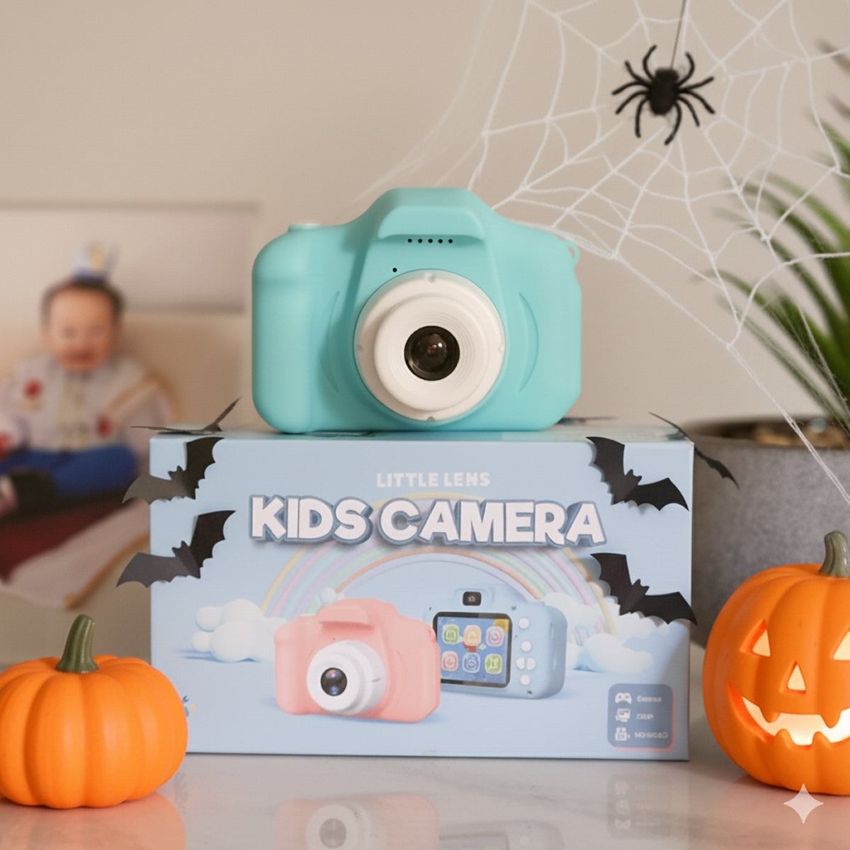 LittleLens Kids Camera Halloween edition in blue with Halloween decorations, kid-friendly toy camera on box with pumpkins and spider web backdrop